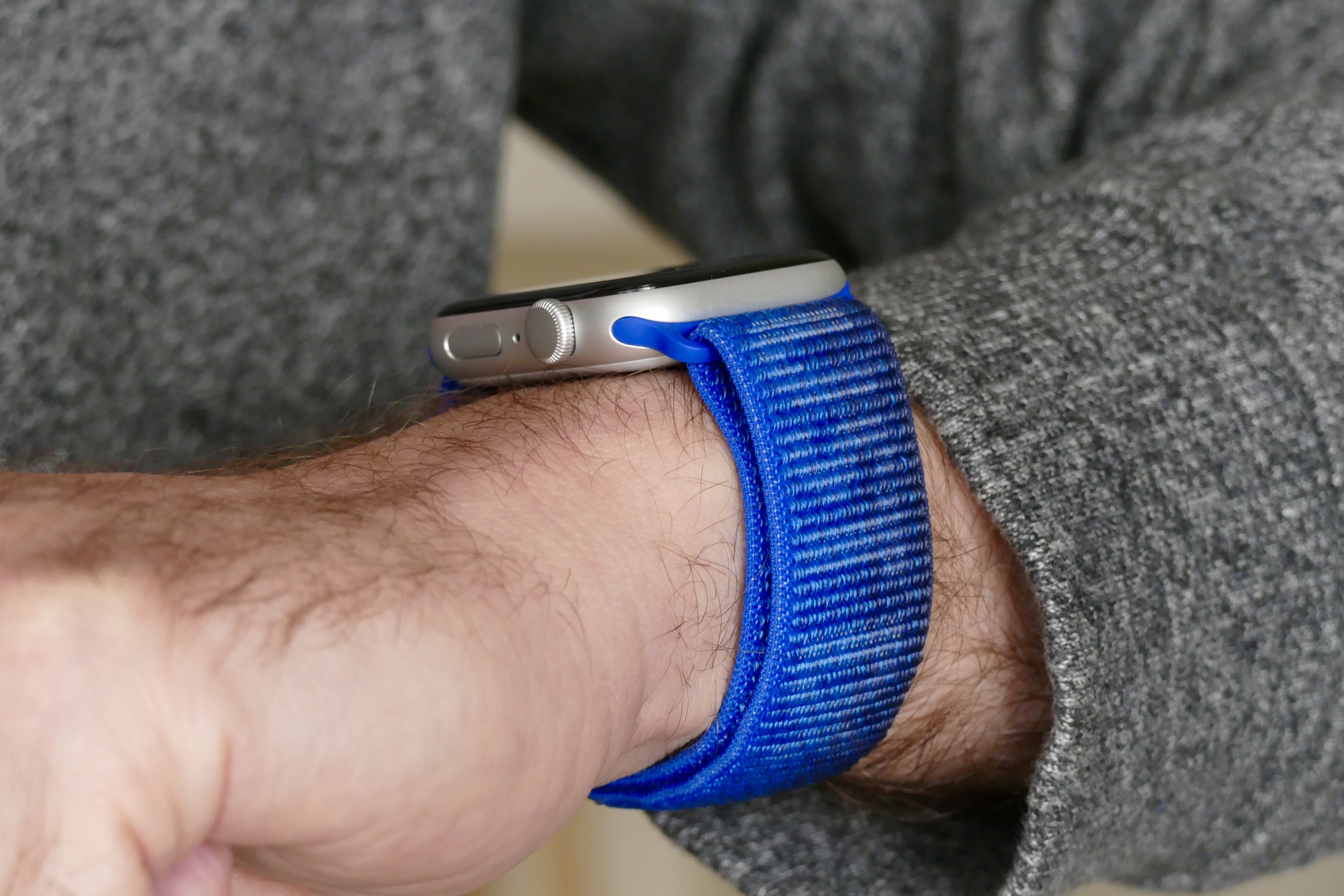 The side of the Apple Watch SE 2 being worn on a man's wrist.