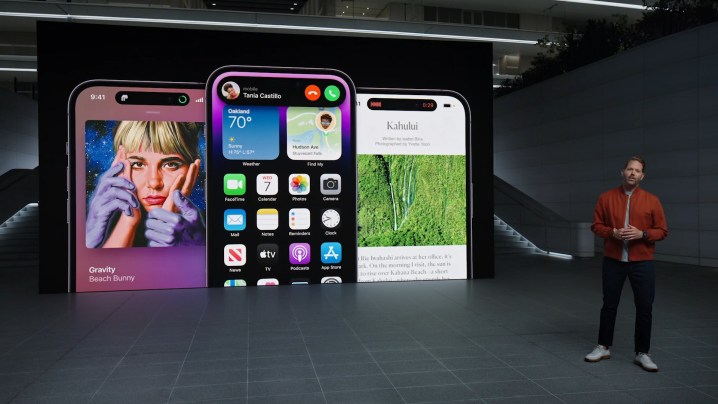 Three iPhone 14 Pro models showing the Dynamic Island, being presented by Apple's Alan Dye.