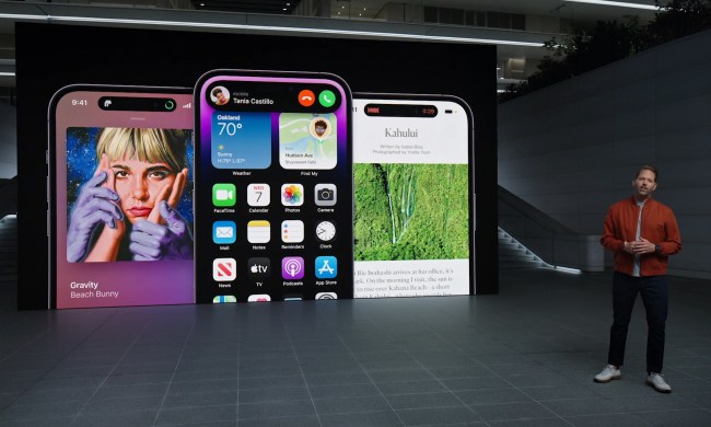 Three iPhone 14 Pro models showing the Dynamic Island, being presented by Apple's Alan Dye.