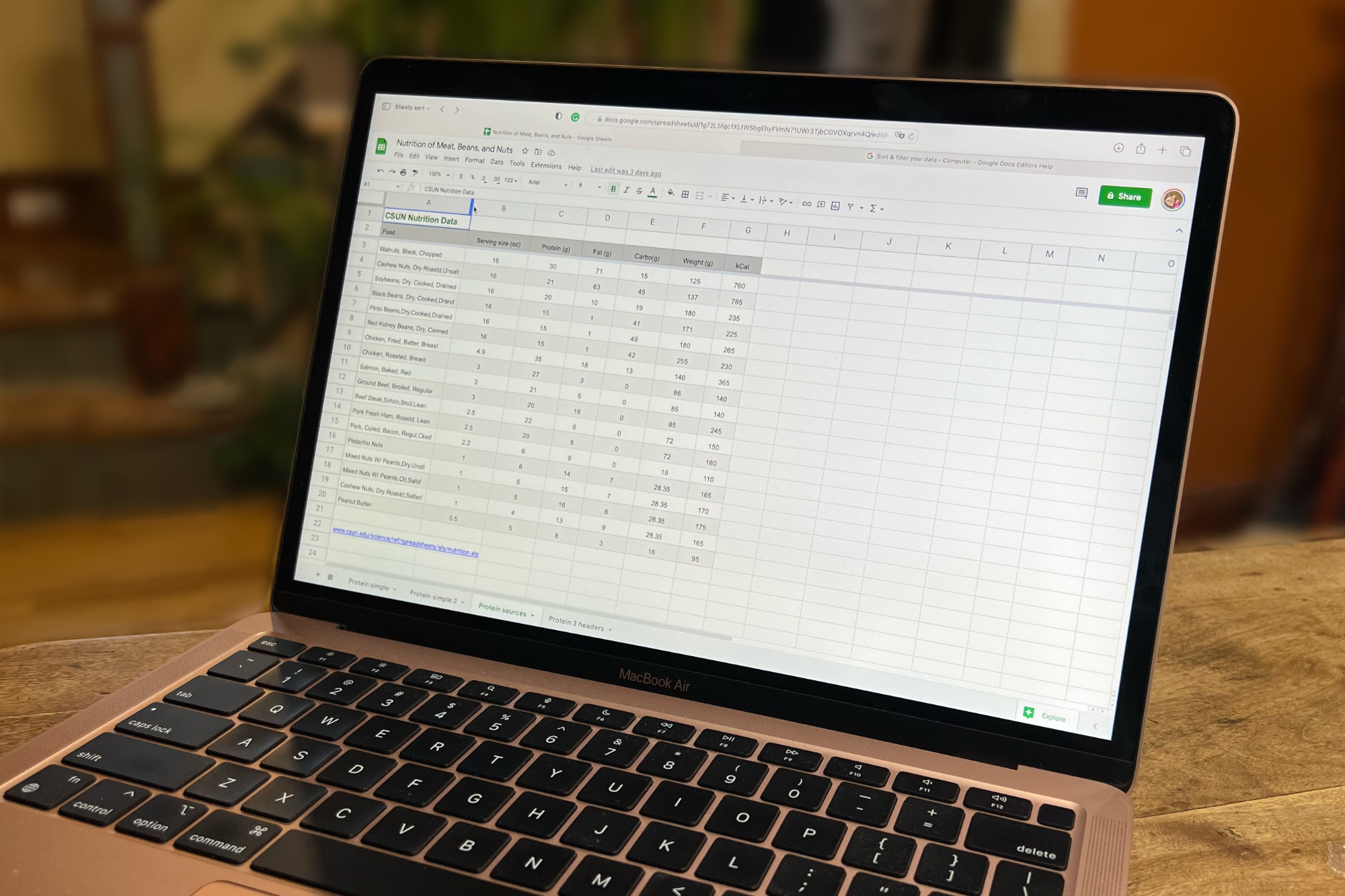 Google Sheets is open in the Safari browser on a MacBook Air.