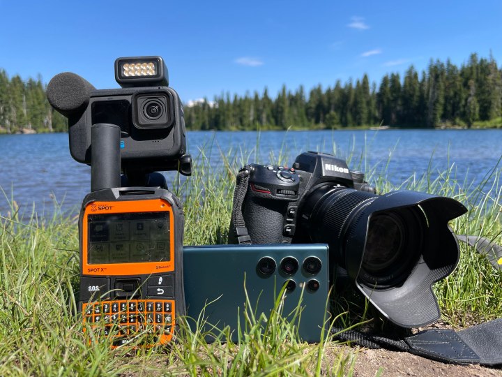 The GoPro Hero 10 Black Creator Edition, Spot X, Samsung Galaxy S22 Ultra, and Nikon Z9 next to an alpine lake.