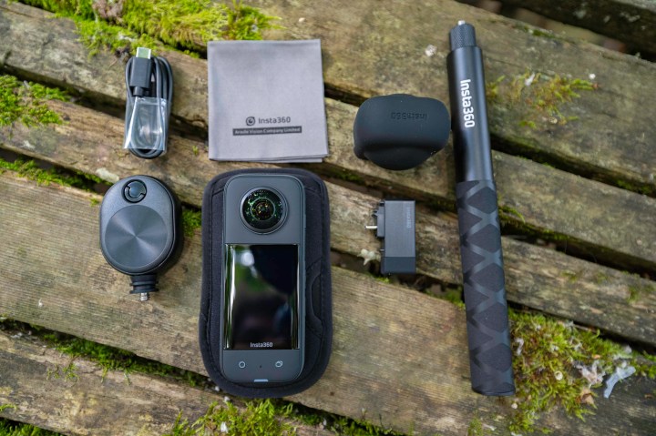The Insta360 X3 with accessories on a picnic table.