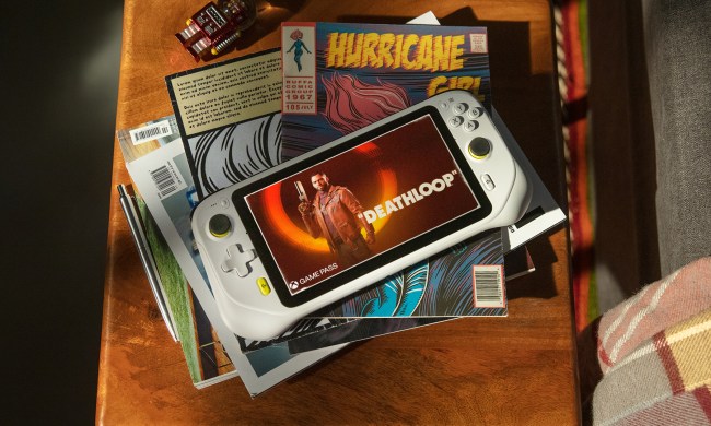 The Logitech G Cloud Gaming Handheld sits on a stack of comics.