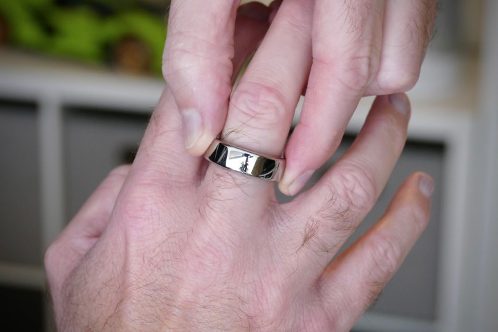 Putting an aura ring on a finger.