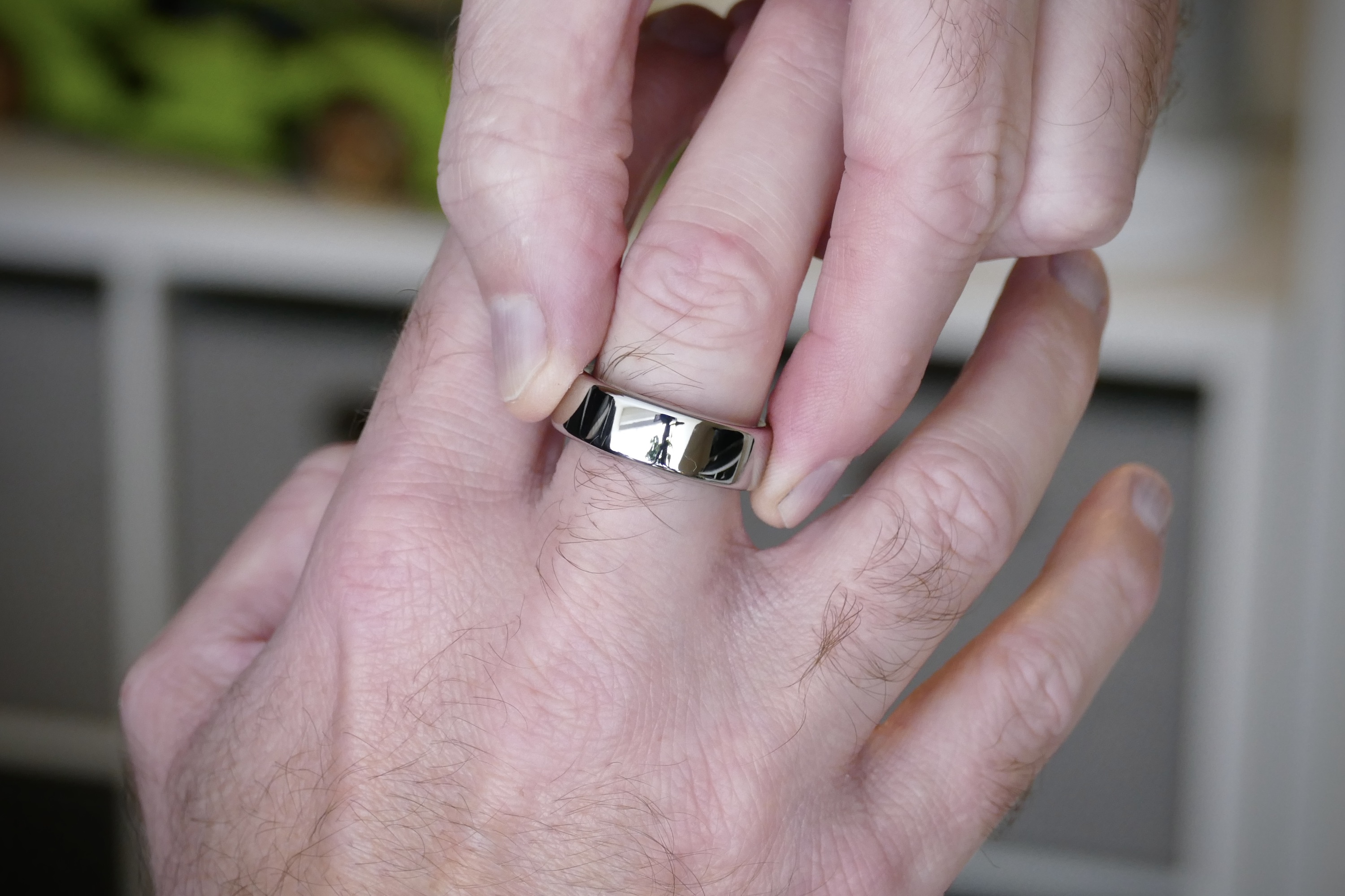 Putting the Oura Ring on a finger.