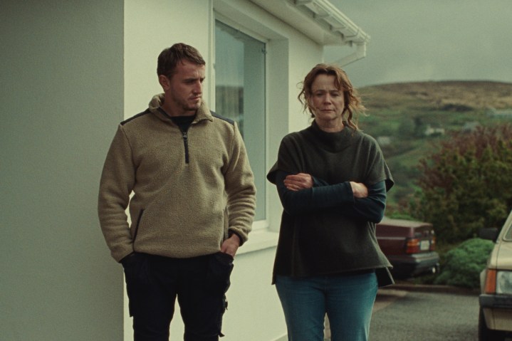 Paul Mescal stands outside a house with Emily Watson in God's Creatures.