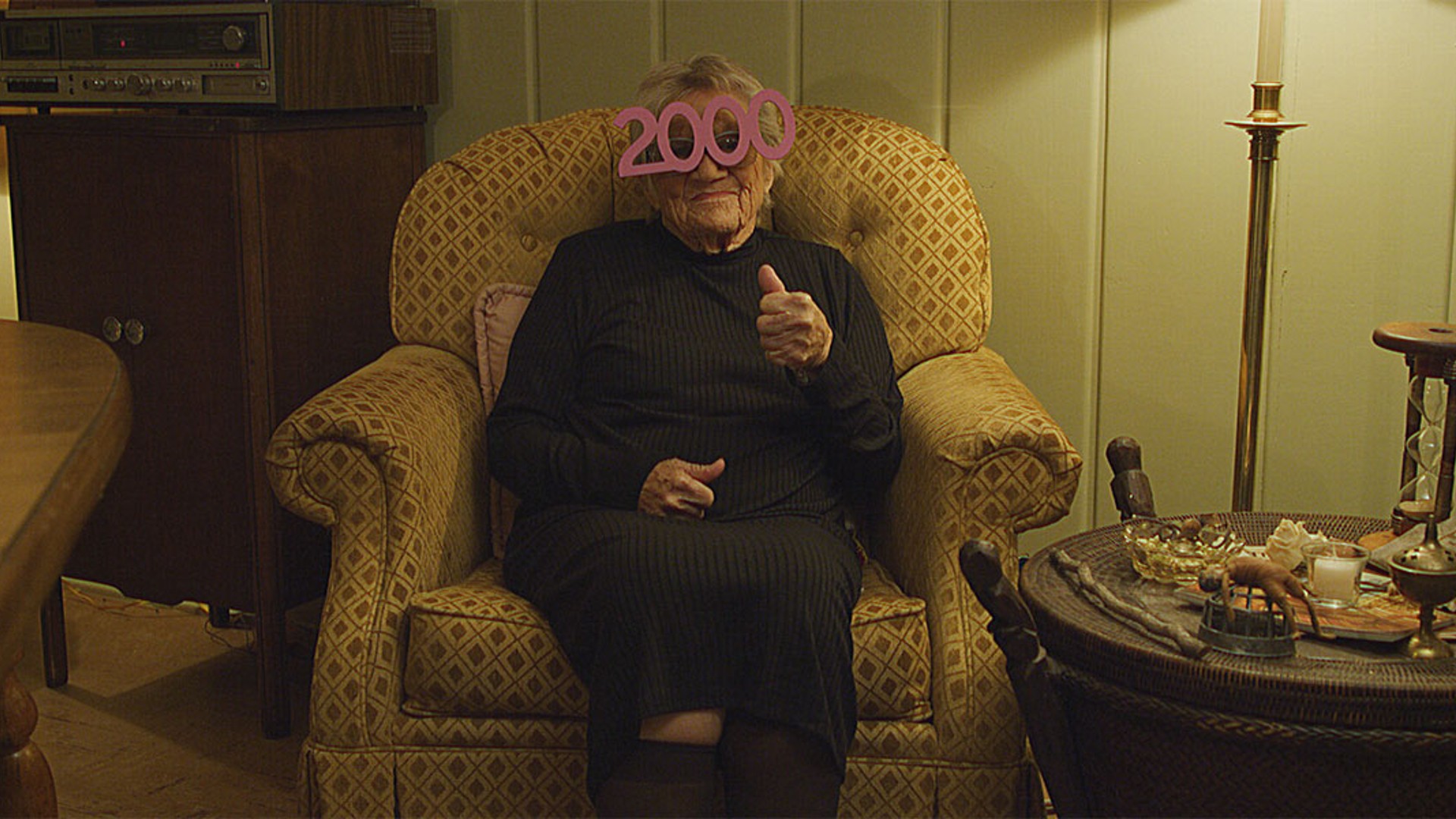 An elderly party guest awaits Y2K.