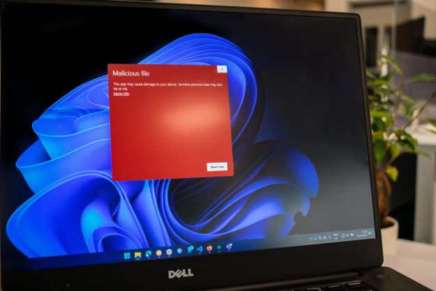 Windows shows a malware warning on a Dell laptop.