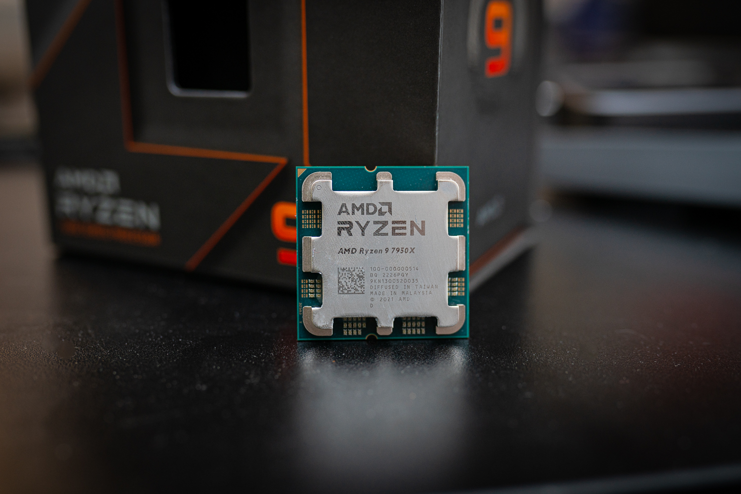 Ryzen 9 7950X अपने बॉक्स के सामने बैठा है।