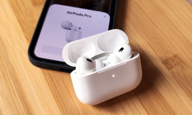 Apple AirPods Pro 2 inside their charging case, near iPhone 14.