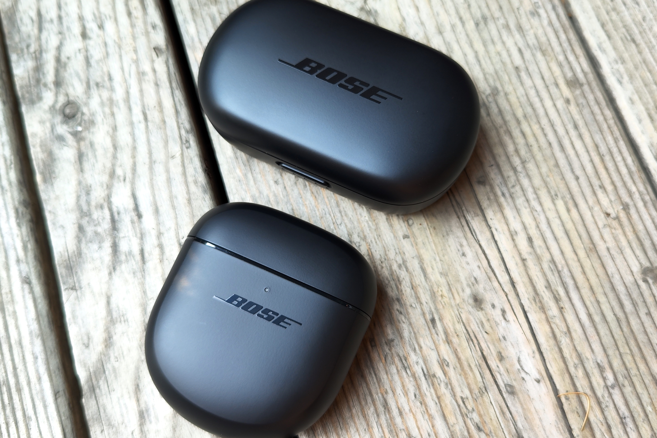 Charging cases for first and second-gen Bose QuietComfort Earbuds.