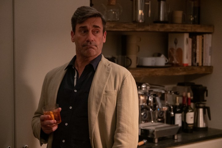 Jon Hamm holds a drink in a scene from Confess, Fletch.