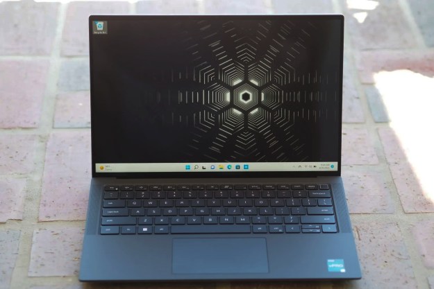 A Dell Precision laptop on a brick floor.