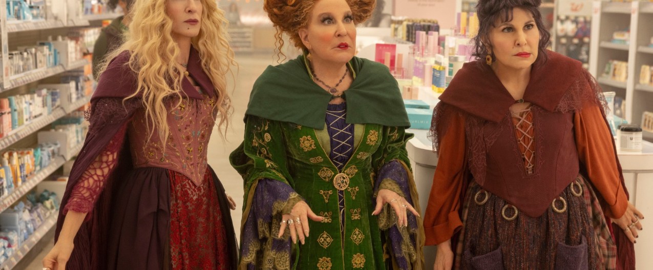 Sarah Jessica Parker, Bette Midler, and Kathy Najimy stand in a convenience store in a scene from Hocus Pocus 2.