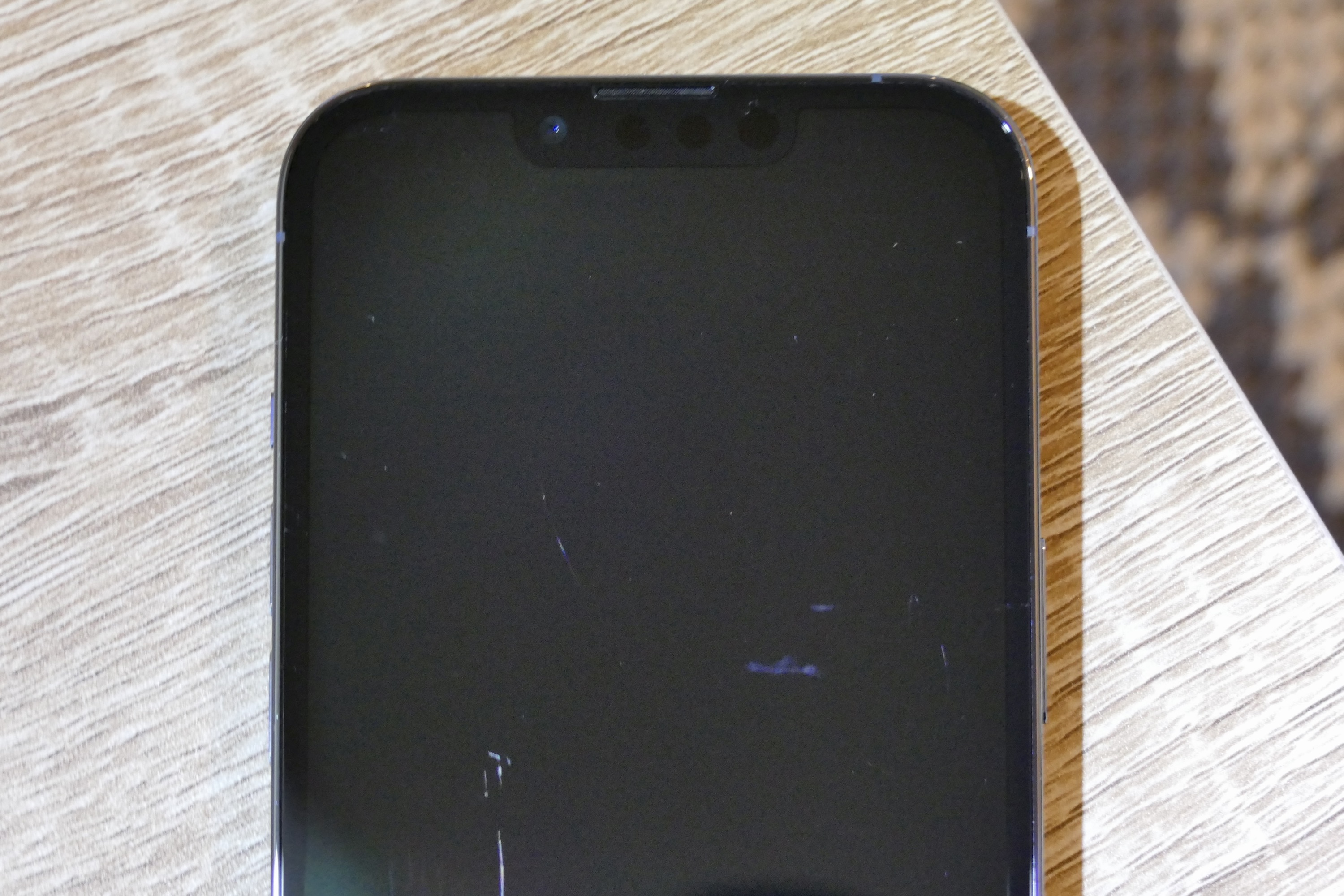 The top of an iPhone 13 Pro showing the Ceramic Shield glass performance.