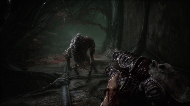 A character points a fleshy rifle at a creature in Scorn.