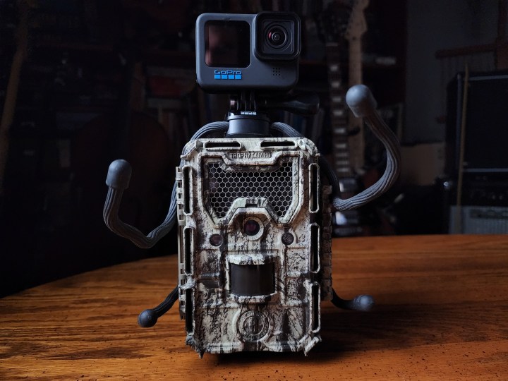 The GoPro Hero 11 Black on top of a Bushnell trail camera.