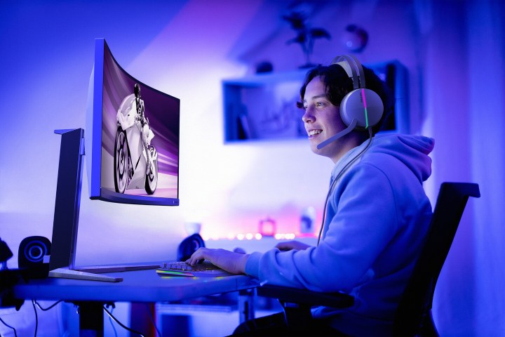 A gamer sits in front of the Evnia Philips gaming monitor.