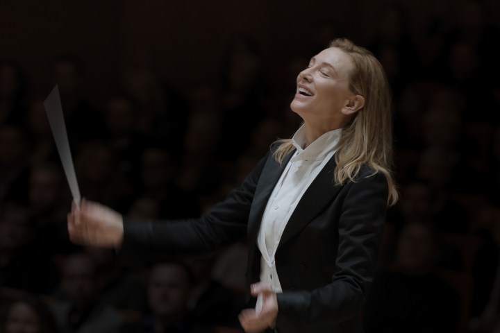 Cate Blanchett conducts music while wearing a suit in TÁR.