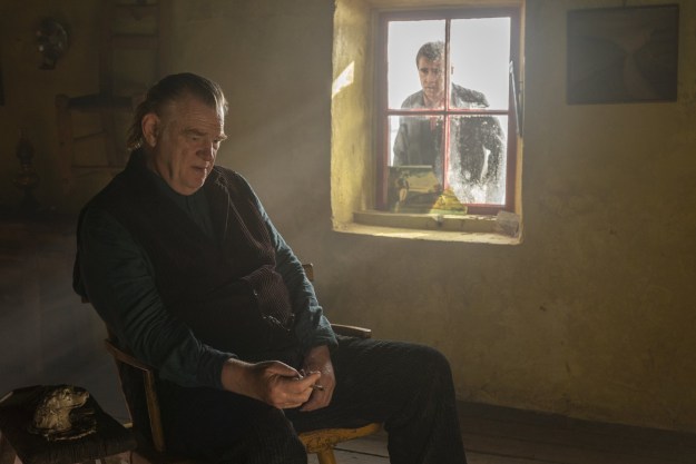 Colin Farrell looks through a window at Brendan Gleeson in The Banshees of Inisherin.