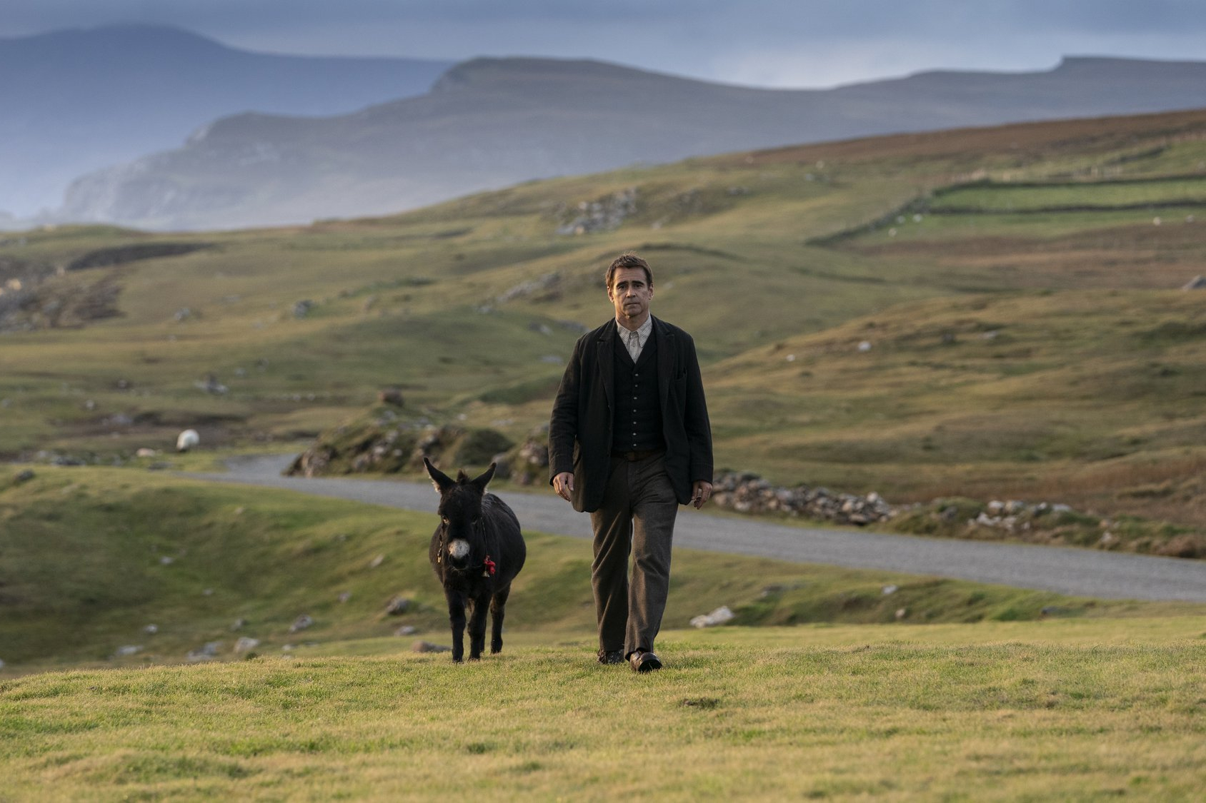 Colin Farrell caminha ao lado de um burro em The Banshees of Inisherin.