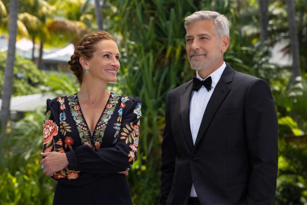 Julia Roberts smiles while looking at George Clooney in Ticket to Paradise.
