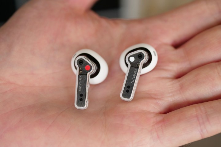 The Nothing Ear Stick earbuds in the palm of a person's hand.
