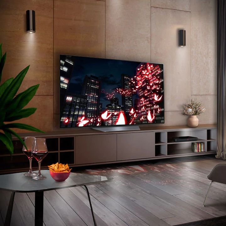 The LG B2 OLED 4K TV sits on a entertainment center in a living room.