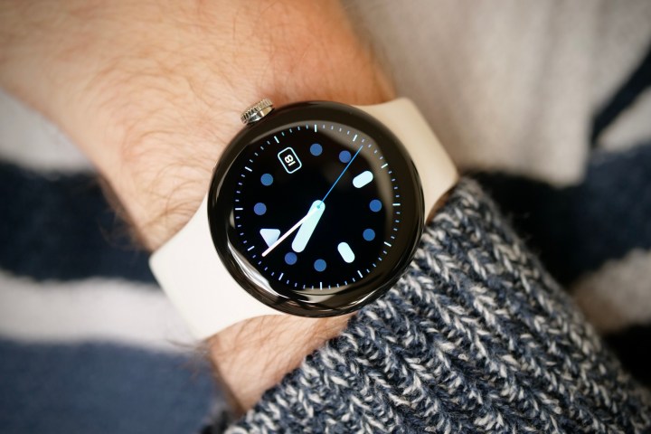 The Google Pixel Watch is worn on a man's wrist and displays the Pacific watch face.