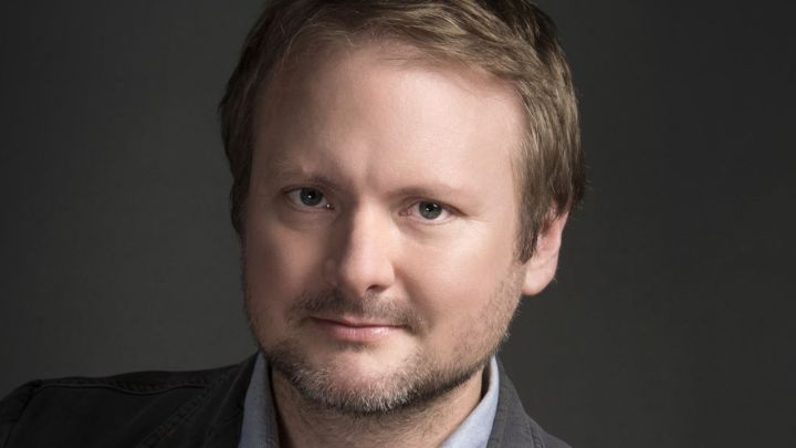 A promotional still of RIan Johnson looking at the viewer with a serious expression.