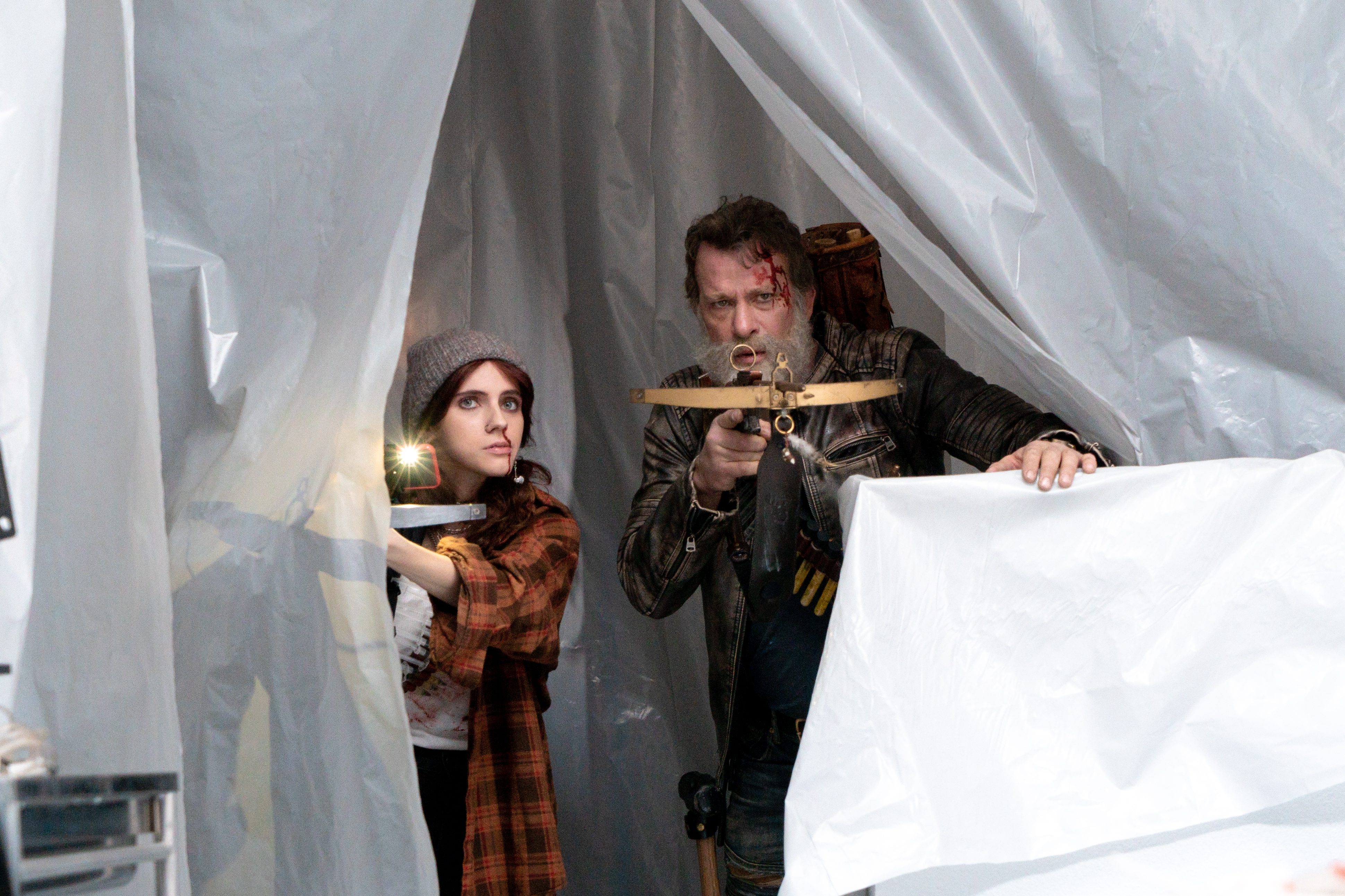 Thomas Jane and Kara Hayward point crossbows in a scene from Slayers.