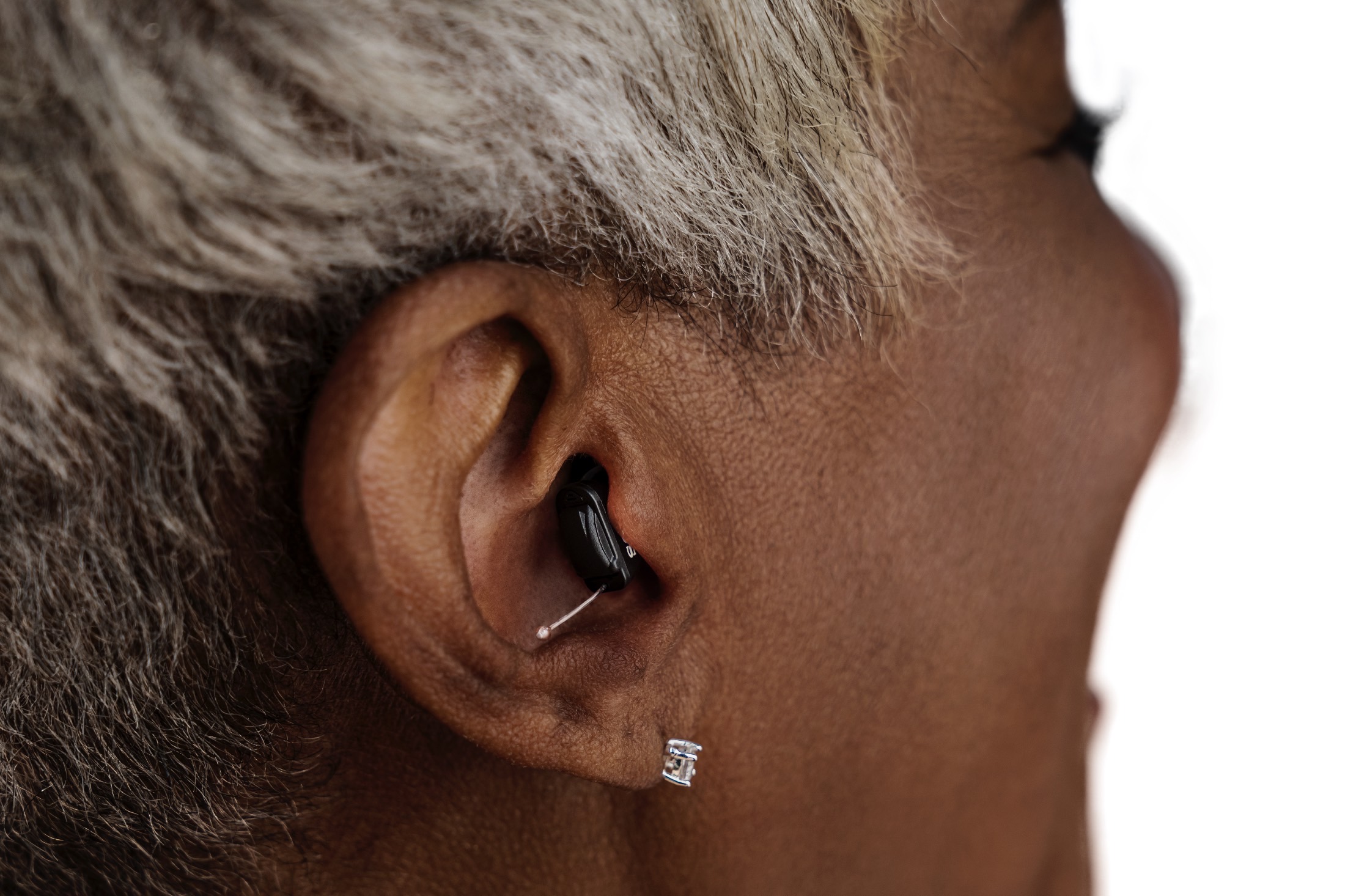 Woman wearing Sony CRE-C10 OTC hearing aids.