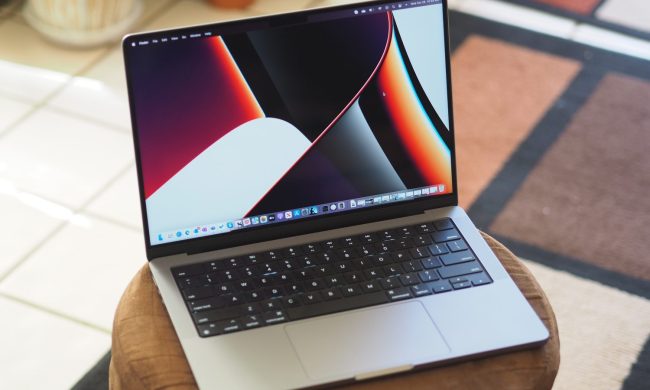 An Apple MacBook Pro 14 sits open on a table.