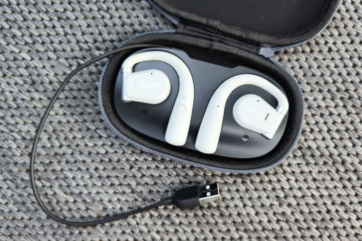 cleer arc open earbuds sitting in charging case with usb cord unwrapped.