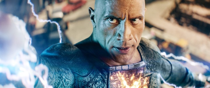 Dwayne Johnson launches lightning from his hand in a scene from Black Adam.