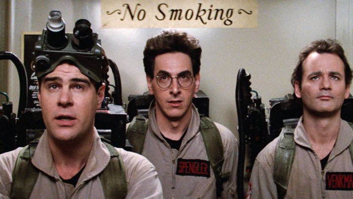 The three main characters from the original Ghostbusters film in full outfits.