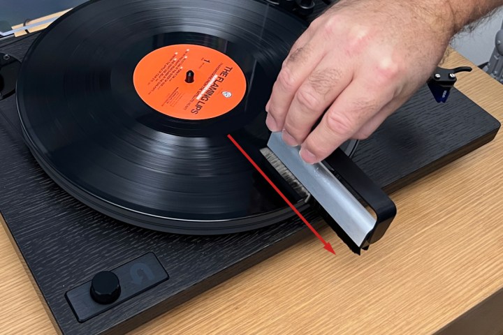Slide the anti-static brush off the record.