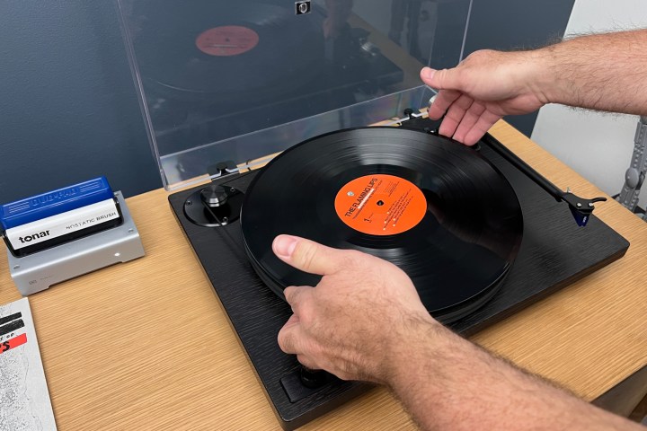 Put a record on a turntable.