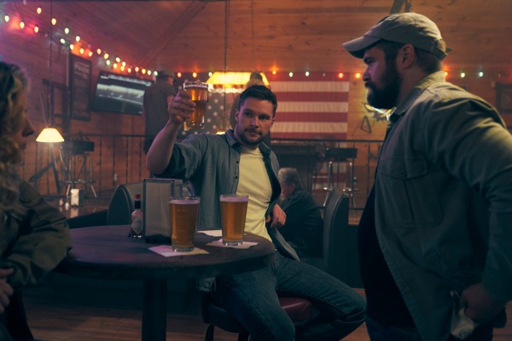 Jack Reynor raises a drink in a scene from The Peripheral.