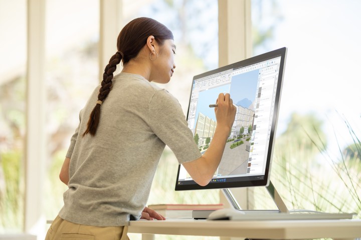 Woman using Microsoft Surface Studio 2+.