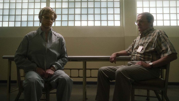 Jeffrey Dahmer sitting with his father in a scene from Monster: The Jeffrey Dahmer Story.