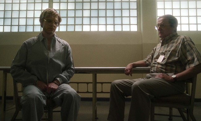 Jeffrey Dahmer sitting with his father in a scene from Monster: The Jeffrey Dahmer Story.