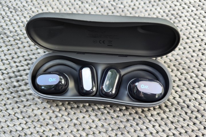Oladance Wearable Stereo open earbuds sitting in charging case.