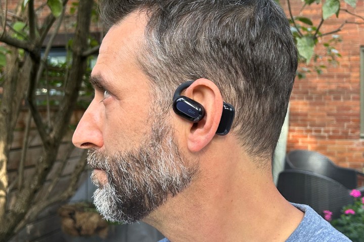 man wearing oladance wearable stereo open earbuds.