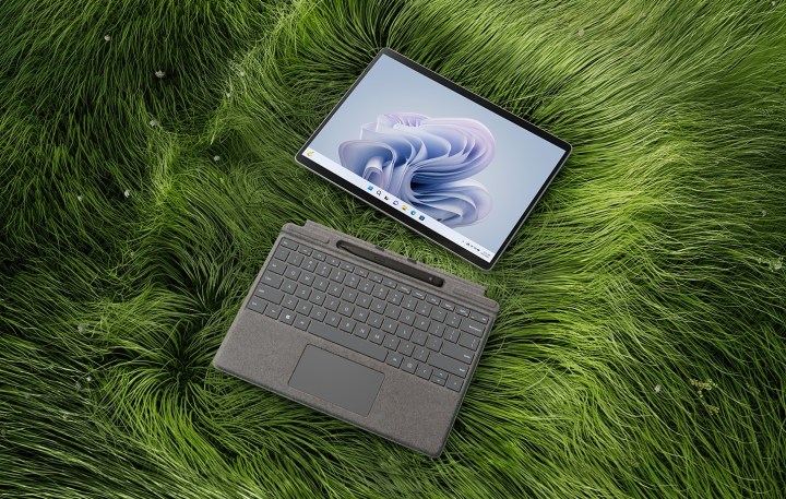 The Surface Pro 9 in grass, separated from the keyboard.