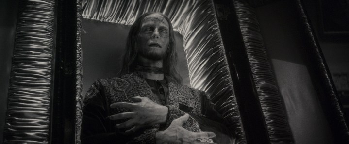 A mummified character reclines in a coffin in a scene from Werewolf By Night.