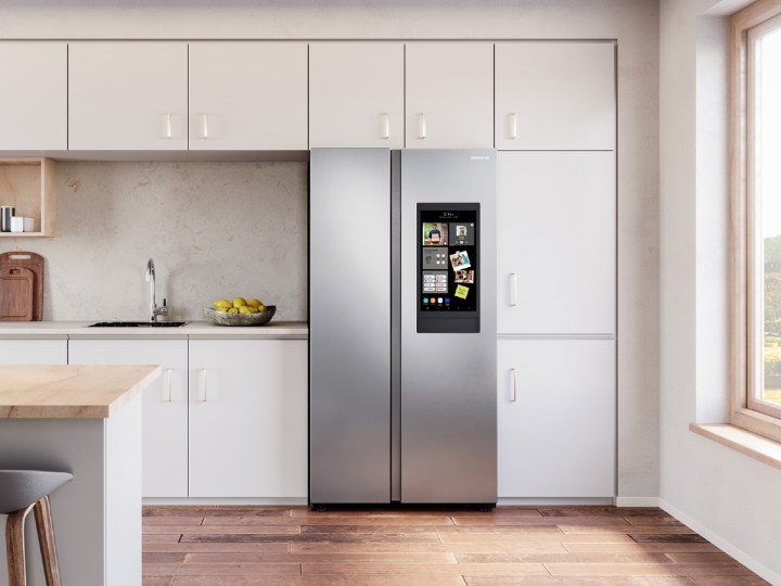 27.3-cubic foot Samsung Smart Side-by-Side Refrigerator with Family Hub in a kitchen with light cabinets and wooden floor.