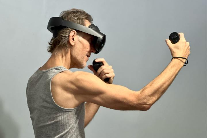 Playing a fitness game in VR with the Quest Pro.