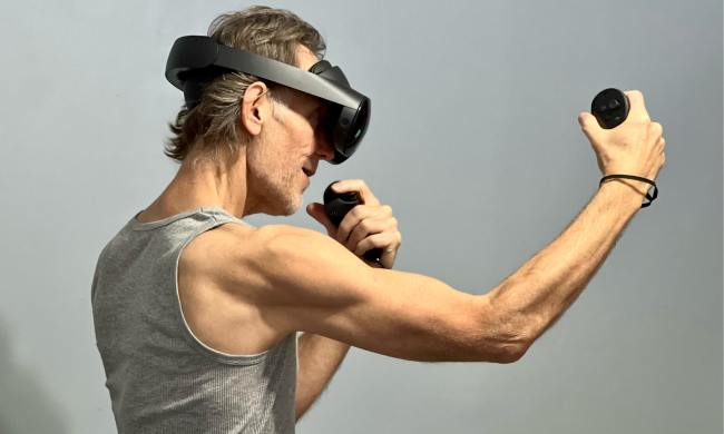 Playing a fitness game in VR with the Quest Pro.