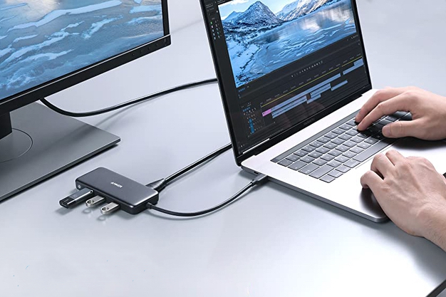 Anker USB-C 7-in-1 Hub with laptop and screen.